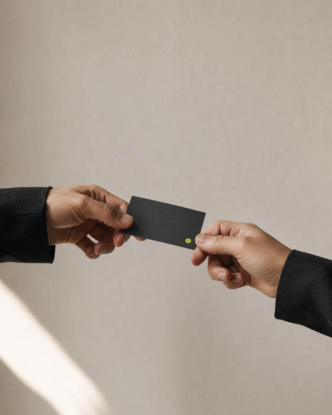 A black card passing from one hand to another